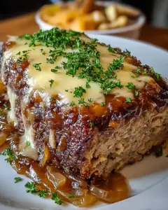 A delicious plate of Crockpot French Onion Meatloaf with Melted Swiss Cheese